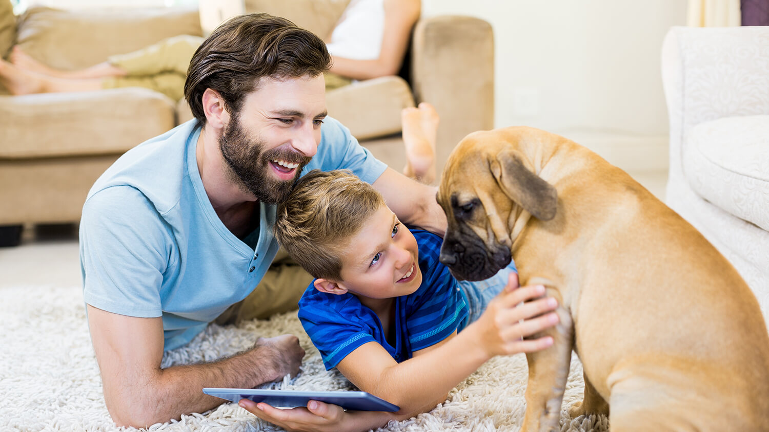 Family playing with dog in pest free home